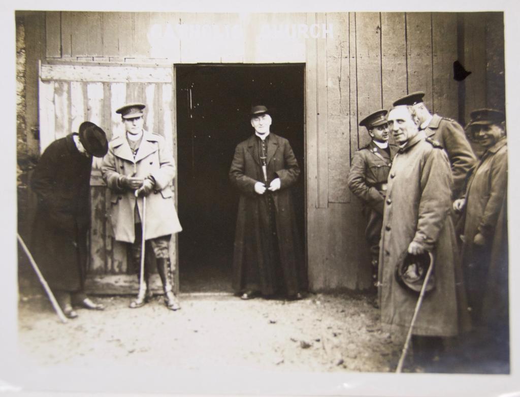 Cardinal Bourne emerges from a wooden hut used as a Catholic church after celebrating Mass with Army Chaplains while visiting the troops at the Front. (Photo from the Westminster Diocesan Archives)