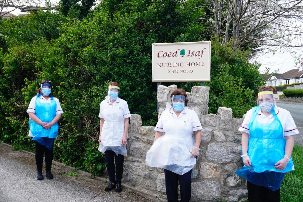 Staff at a care home in North Wales, wearing PPE made at St Benedict's School, Ealing