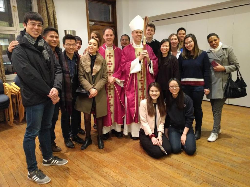 Bishop Nicholas Hudson, Fr Stephen Wang and students at Newman House