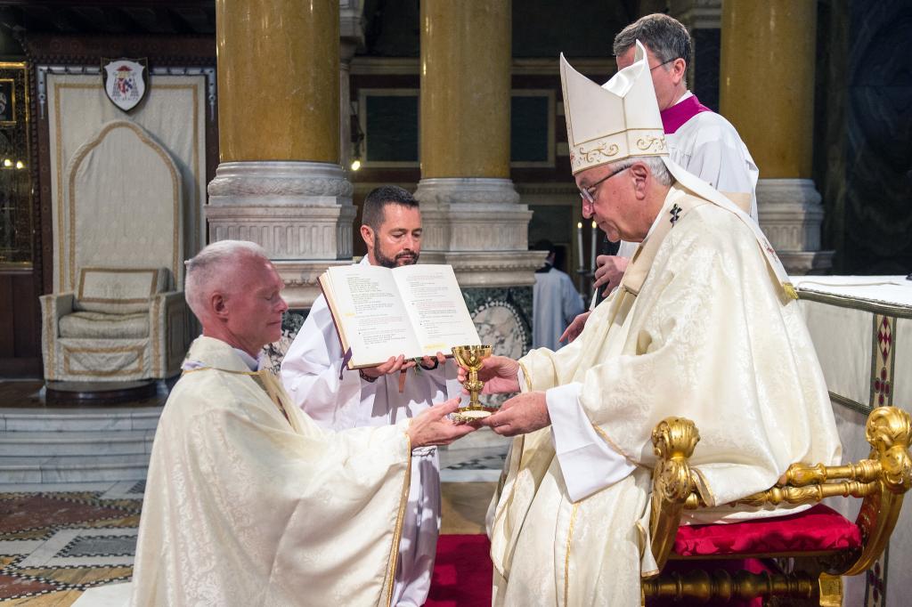 Fr Julian received the paten and chalice